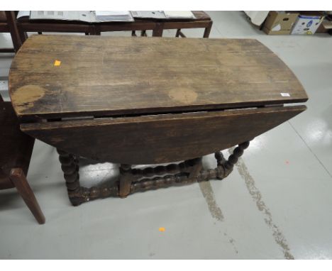 A part 18th century gate leg dining table having drop leaf pine top, on oak bobbin gate legs