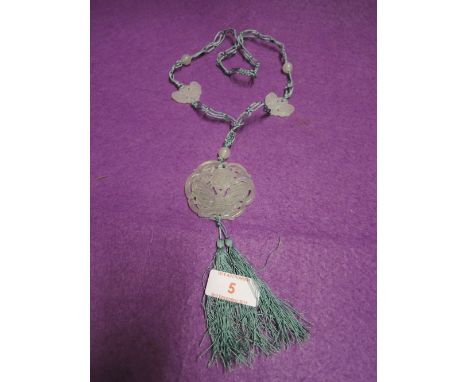 A jade pendant and beaded necklace with moth or butterfly decoration