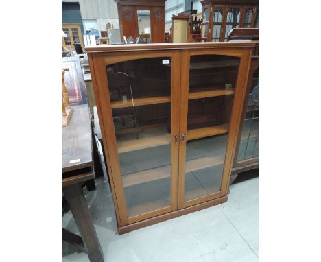 A 20th Century light mahogany display cabinet