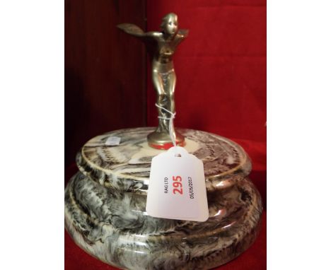 A Rolls Royce 'Spirit of Ecstasy' car mascot housed on a marble base     It measures approx 11cm high, 16.5cm overall. The pl