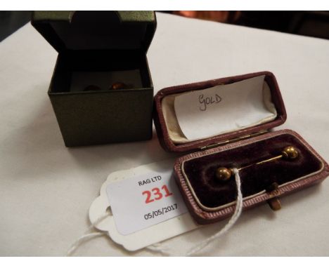 A pair of 9ct gold studs and a gold tie pin