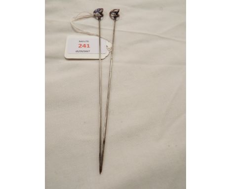 A pair of Art Nouveau Charles Horner hat pins in knot design with blue enamelled forget-me-nots, both marked 'Sterling' with 