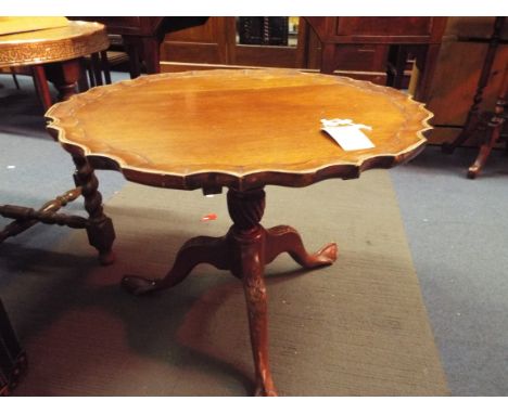 A tripod mahogany tea table with a pie crust top