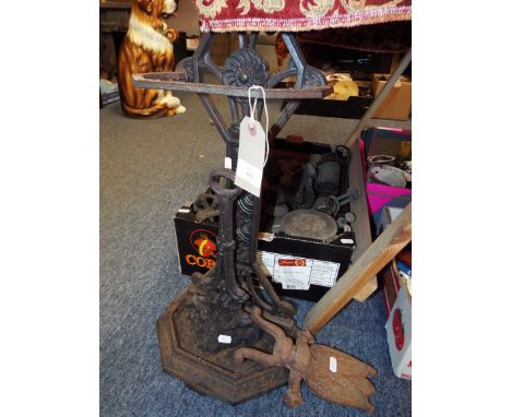 A cast metal stick and umbrella stand with drip tray together with doorstop and a boot pull in the form of a beetle