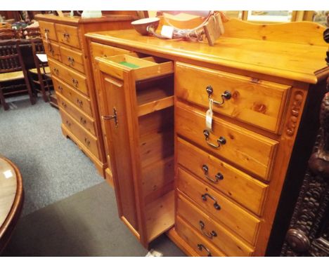 A gentleman's pine dressing chest having twelve short drawers the central pull out having shoe and tie compartment