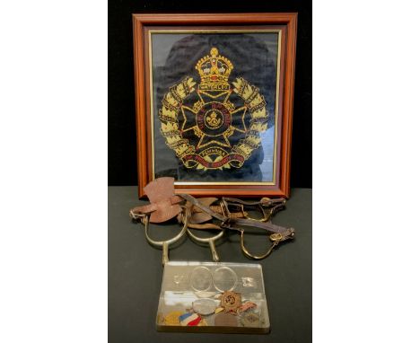 A pair of World War one Cavalry spurs, others Royal Army Service Corp cap badges, hand embroidered Rifle Brigade crest etc 