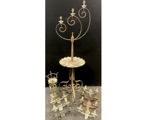 A wrought iron floor-standing three branch candelabra, by Stephen Glover, Walsall, 155cm high x 50cm;  seven metalwork two-br