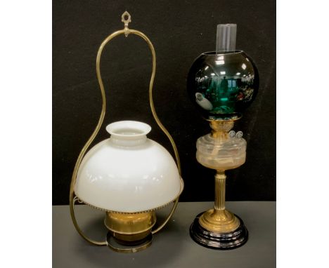 A Victorian oil lamp, clear moulded glass reservoir, brass reeded column, ring stepped foot, black socle, deep green globular