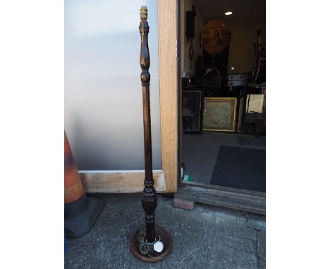 A polished as mahogany standard lamp, on circular base, 48" high