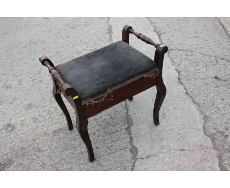 An oak framed piano stool, on cabriole supports, upholstered in a brown floral patterned fabric, with lift-up top, 35" wide x