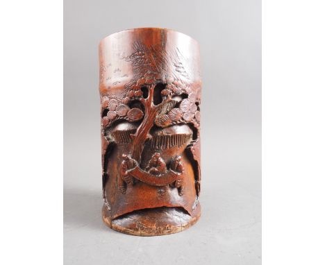 A Chinese carved bamboo brush pot with sages unrolling a scroll, 7 1/2" high