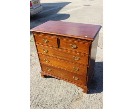 A well reproduced oak chest of two short and three long graduated drawers, on bracket supports, 36" wide x 19" deep x 37" hig