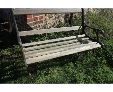 A cast iron garden bench with slatted back and seat, 44" wide