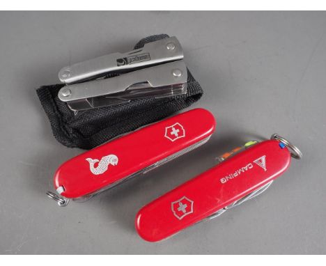 A Victorinox Swiss Army "Camper" pocket knife with fire light and kindling, and a Swiss Army "Fisherman" pocket knife, in ori