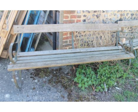 A wrought iron scrolled arm garden bench with slatted seats, 72" wide