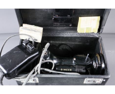 An early 20th century Singer electric sewing machine with instructions and foot control, in fitted case