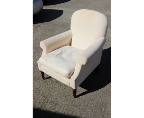 An armchair with loose seat cushion and loose covers, on turned supports