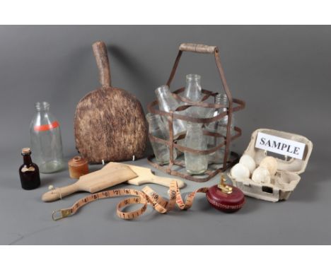 Two butter pats, a similar bread paddle, four dummy eggs, a collection of glass bottles and other similar items