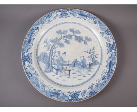 A Chinese blue and white charger with figures in a garden decoration, 21 1/4" dia