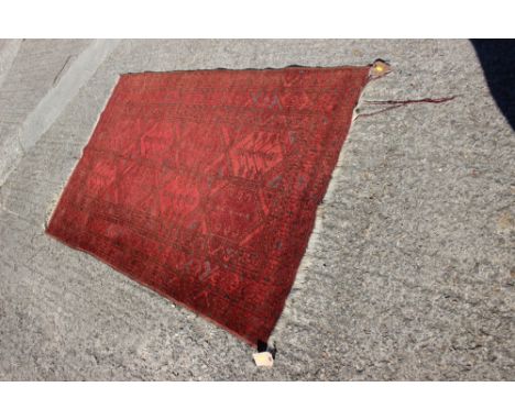 A Persian rug of traditional design with eight central medallions on a red ground, 67" x 43" approx