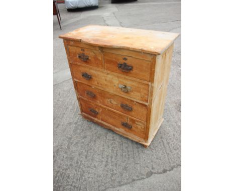 A stripped pine break bowfront chest of two short and three long drawers, on bracket feet, 36" wide x 18" deep x 39" high
