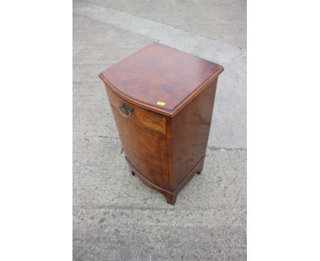A walnut and banded bowfront bedside cupboard, on bracket feet, 14" wide x 13 1/2" deep x 26 1/2" high