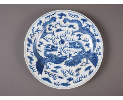 A Chinese blue and white plate with dragon, cloud and flaming pearl decoration, seal mark to base, 10 1/4" highCondition:Some