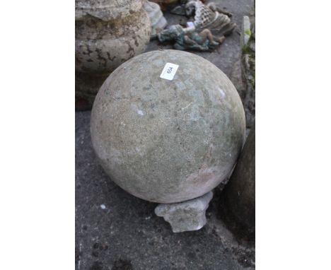 A cast stone spherical finial, 12" dia x 14 1/2" high (including lower section)