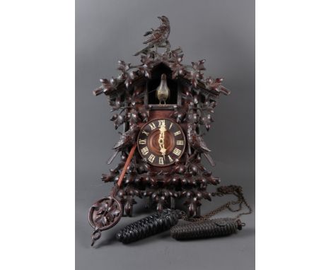 A Camerer Kuss & Co Black Forest carved cuckoo clock with weights and pendulum, 23 3/4" high 