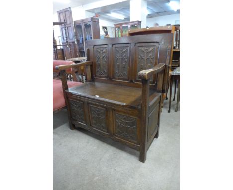 A carved oak hall bench 