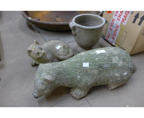 Two concrete garden figures of a cat and badger and a small planter 