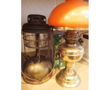 Storm lamp table oil lamp with orange shade and a wall mounted coach lamp