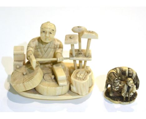 A Meiji period carved ivory okimono of a craftsman together with another netsuke of similar date, man with horse (2)