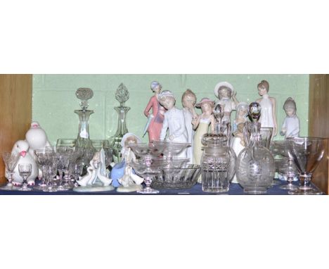 A shelf including assorted Nao figures, glass sundae dishes, two similar decanters and stoppers, cut glass etc 