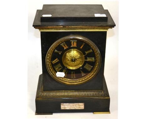 A gilt metal and slate striking mantel clock, the slate chapter ring with gilt metal Roman numerals, with presentation plaque