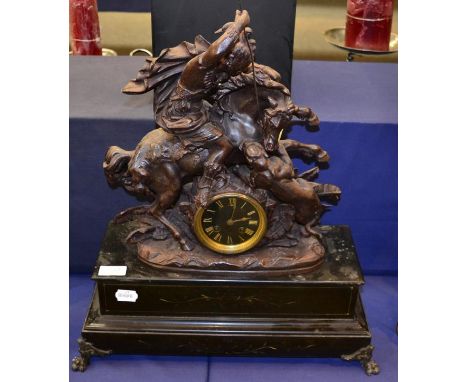 A slate and patinated metal figural striking mantel clock surmounted by a warrior on horseback fighting a lion