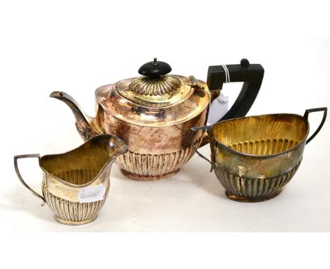 A silver three piece tea set with part gadrooned body comprising teapot, cream and sugar each marked for Birmingham19.3ozt gr