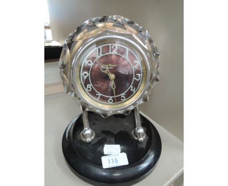 A mid 20th century stylised mantel clock having prism glass bevel on chrome and plastic mount 