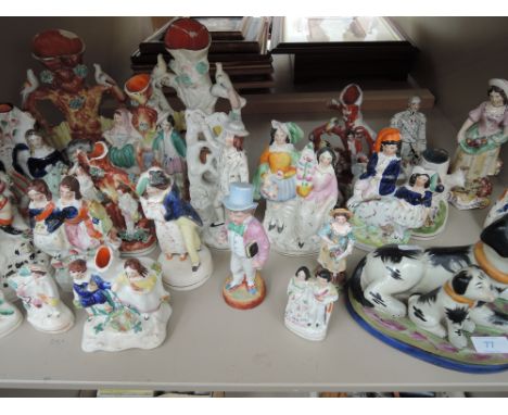 A shelf of Staffordshire figurines 