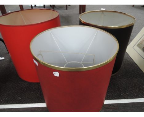 Three lamp shades of large proportion
