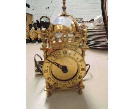 A mid 20th Century brass reproduction lantern clock having quartz movement