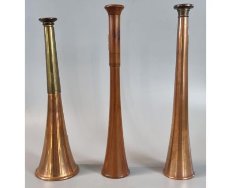 Two vintage copper and brass hunting horns with a similar treen hunting horn.  (3)  (B.P. 21% + VAT) 