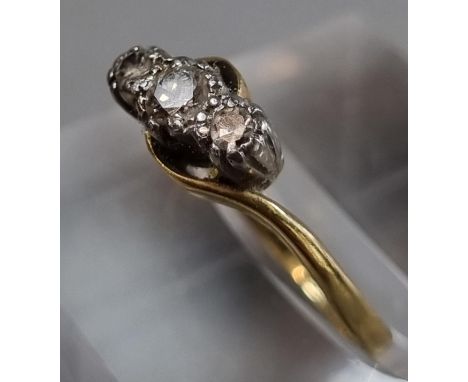 18ct gold and platinum twist shank three stone diamond ring.  1.8g approx.  Size I.  (B.P. 21% + VAT) 