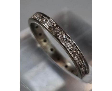 White gold or platinum diamond full eternity ring. Unmarked.  2.21g approx. Size J1/2.  (B.P. 21% + VAT) 