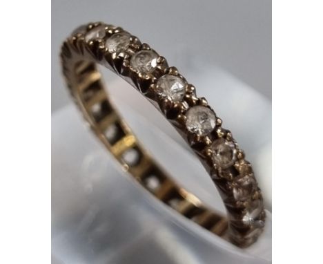 9ct gold full eternity style ring with white paste stones. 1.8g approx. Size M1/2. (B.P. 21% + VAT)