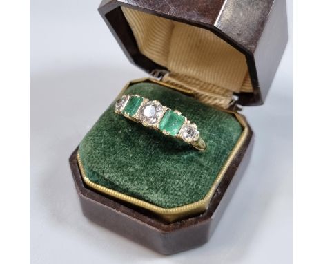 Probably 18ct gold diamond and emerald five stone ring, set with old cut diamonds, the centre stone 0.65 carat approx, in Bak