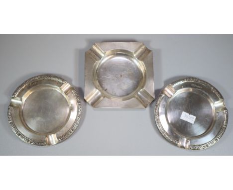 Pair of silver ashtrays with Celtic repeating designs to each border.  London hallmarks, together with another silver engine 