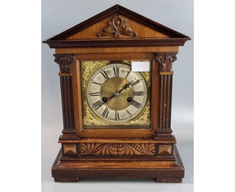 Early 20th century carved architectural design two train mantle clock with silver chapter ring, Roman numerals and gilt folia