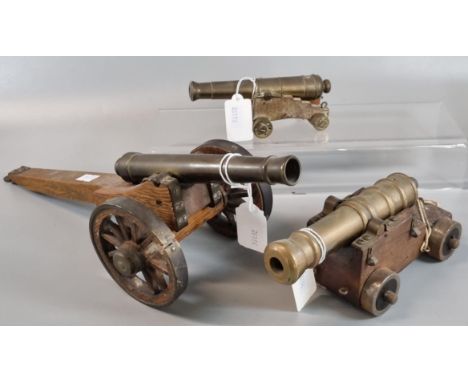 Three vintage cannons on wooden stands with metal and wooden wheels.  (3)  (B.P. 21% + VAT) 