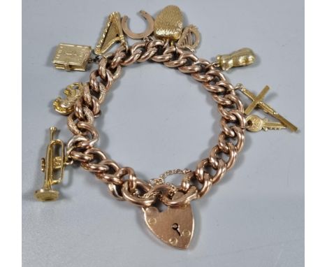 9ct gold curb link charm bracelet with assorted charms including: heart shaped padlock, harp, trumpet etc.  38g approx.  (B.P